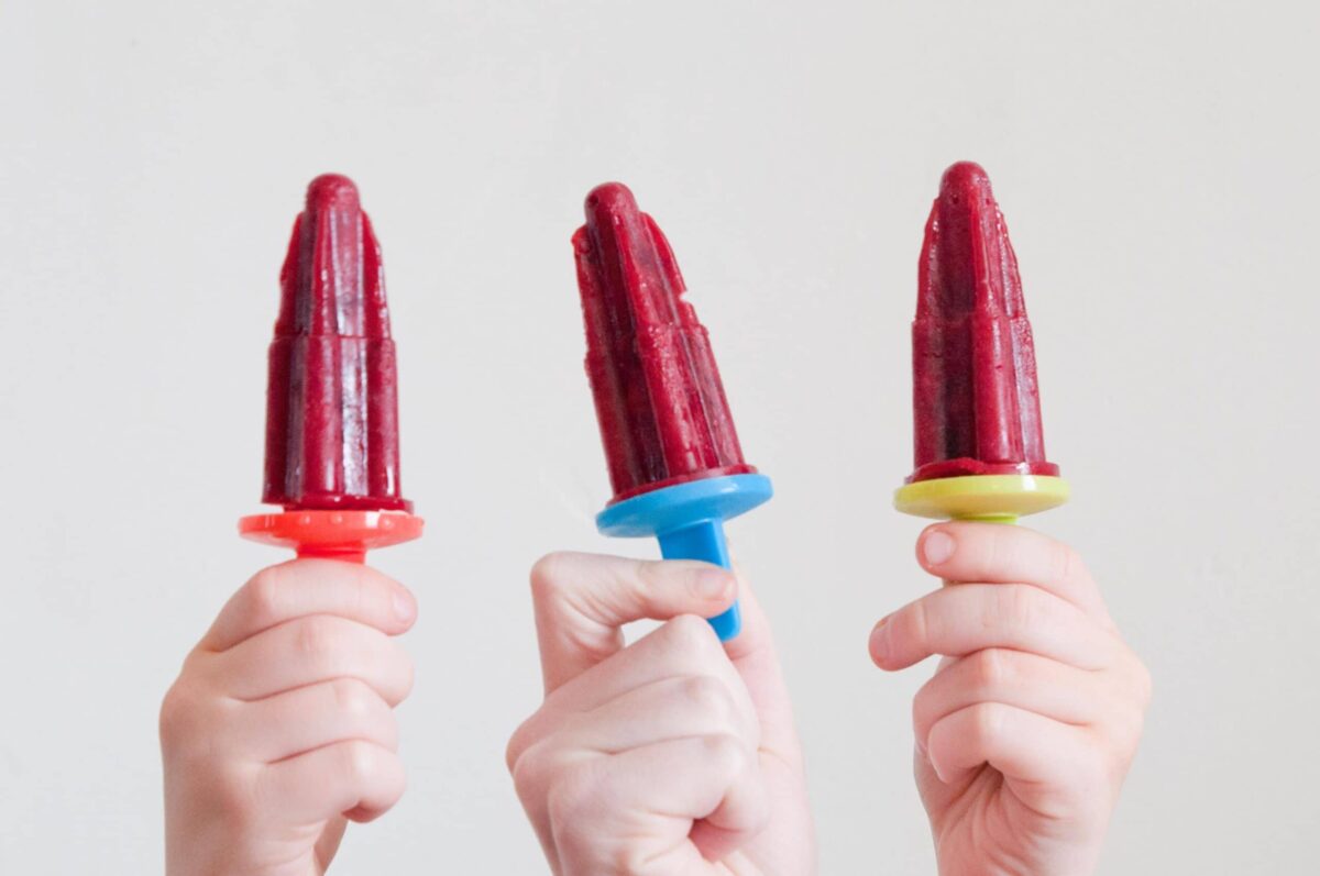 Homemade cherry pops being held up 