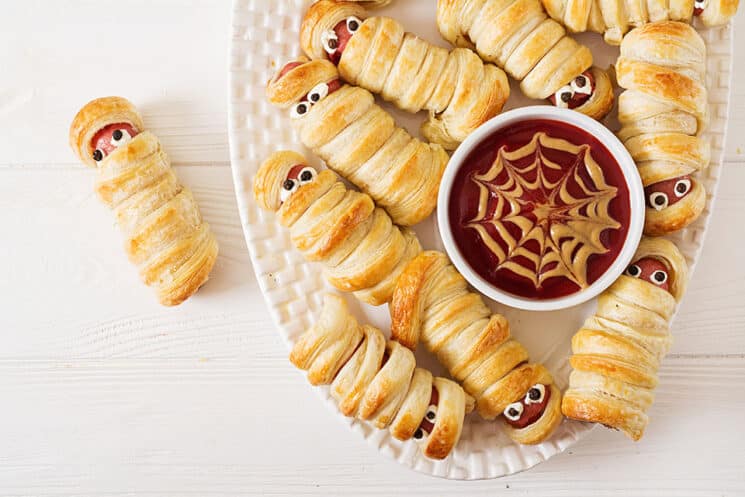 mummy hot dogs top view close up with spiderweb ketchup and mustard