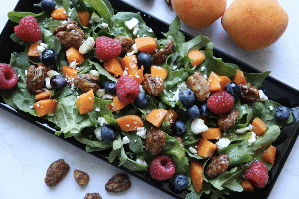 apricot berry argula salad topped with feta and glazed pecans
