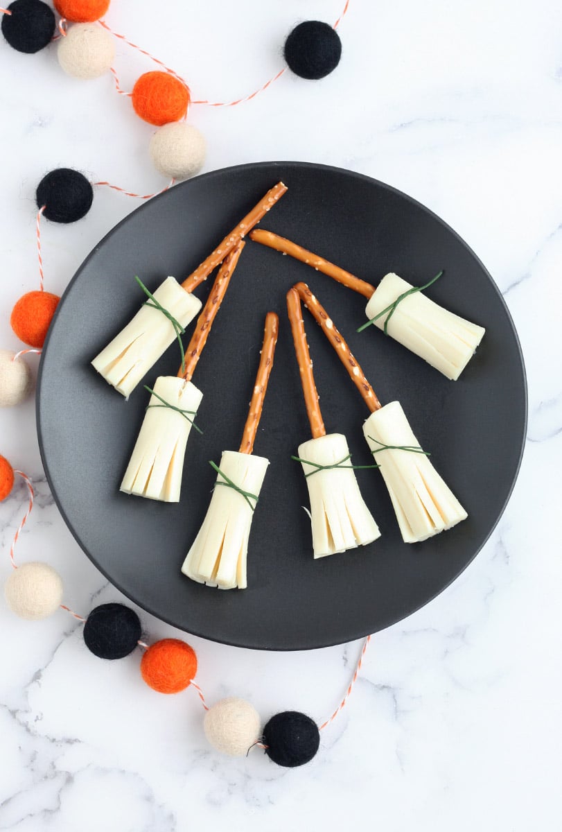 witches' broom snacks on a black plate