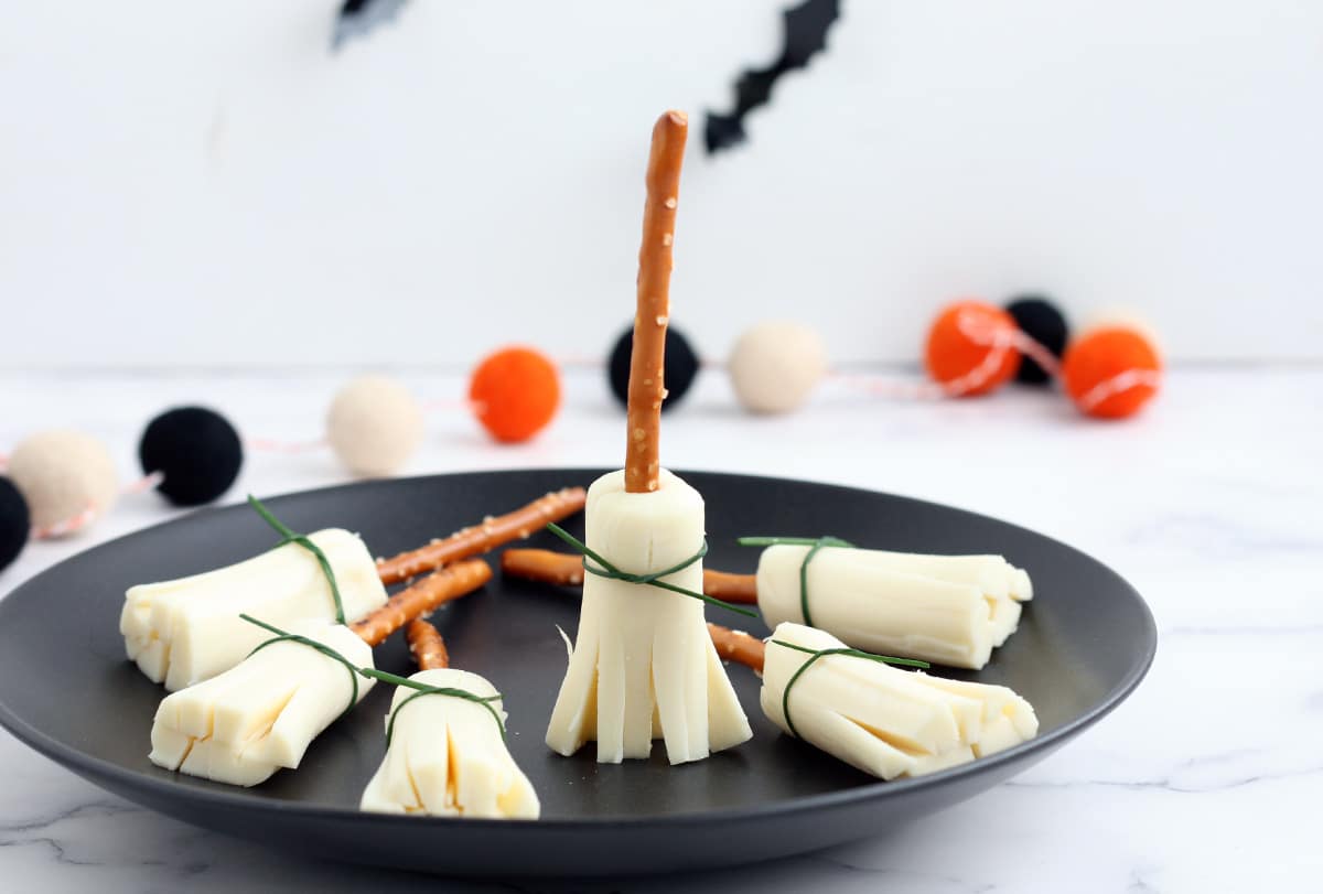string cheese and pretzels made to look like a broom