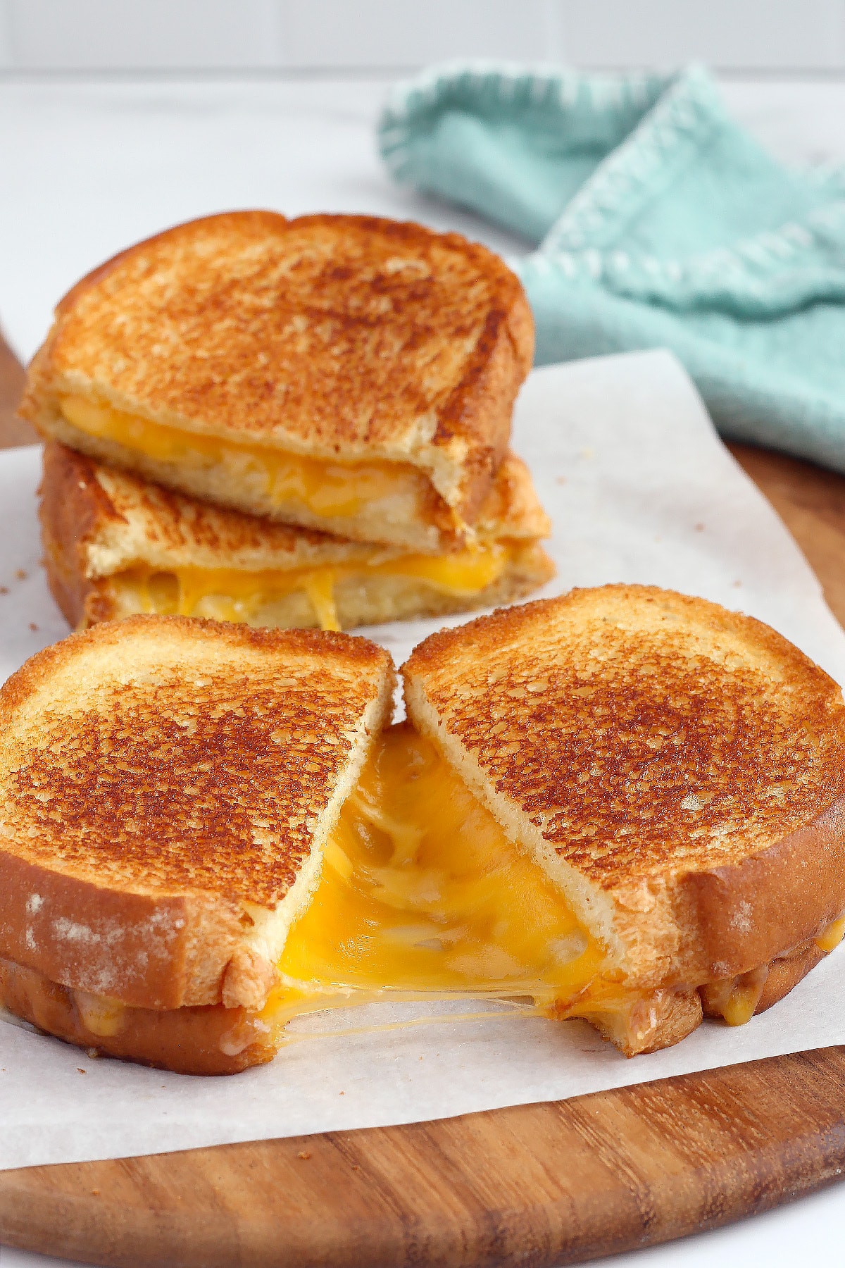 A gooey, melty grilled cheese sandwich on french bread with a golden crust. 