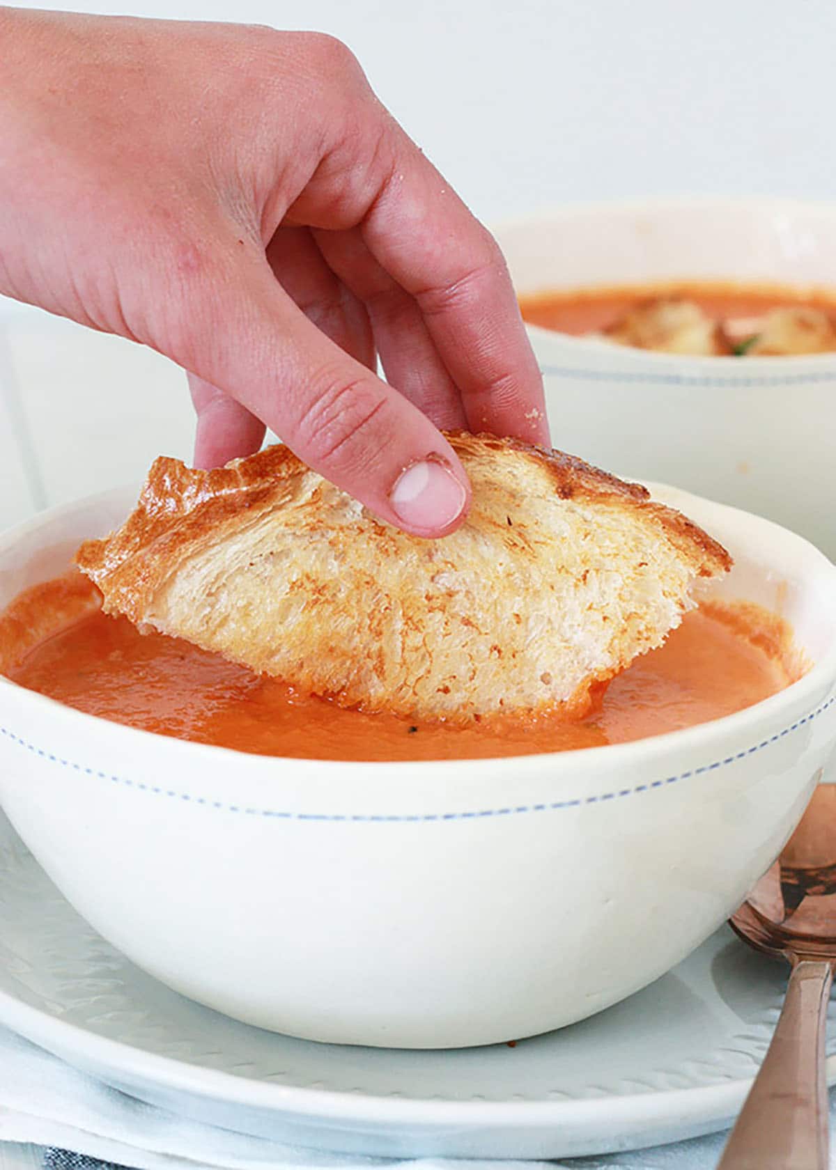 grilled cheese dipped in creamy tomato basil soup