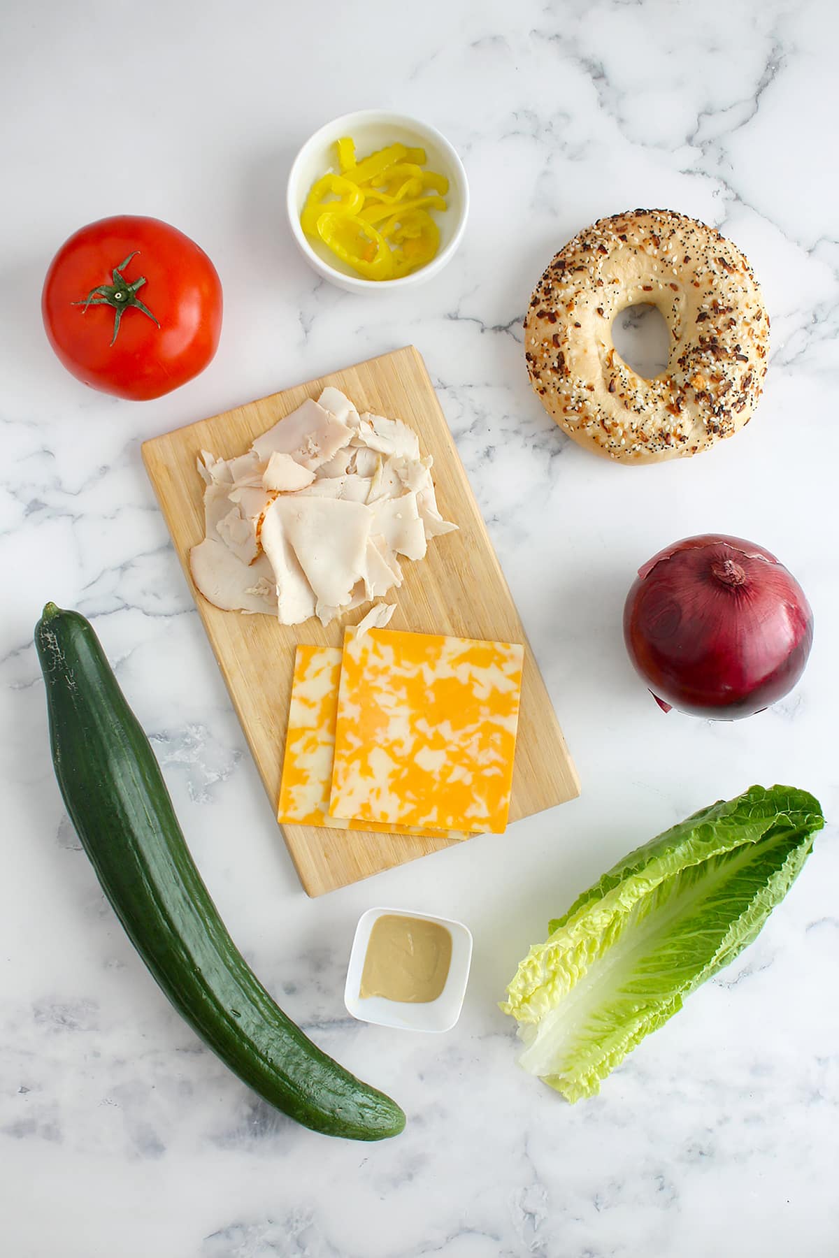 Ingredients needed to make turkey bagel sandwiches. 